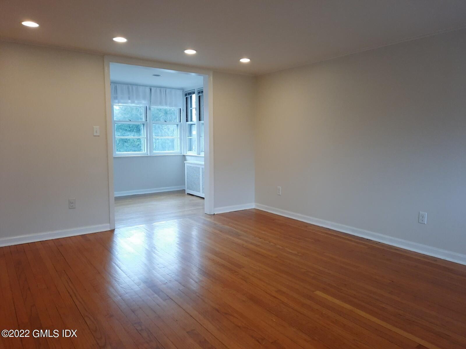 13 High Street Greenwich, CT 06830 - Photo 2 of 21 a view of an empty room with wooden floor and a window