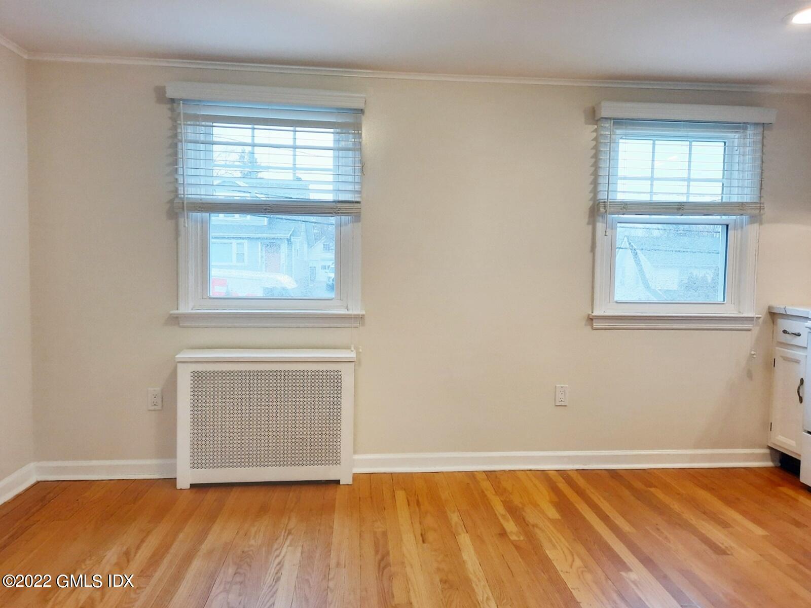 13 High Street Greenwich, CT 06830 - Photo 5 of 21 an empty room with wooden floor and windows
