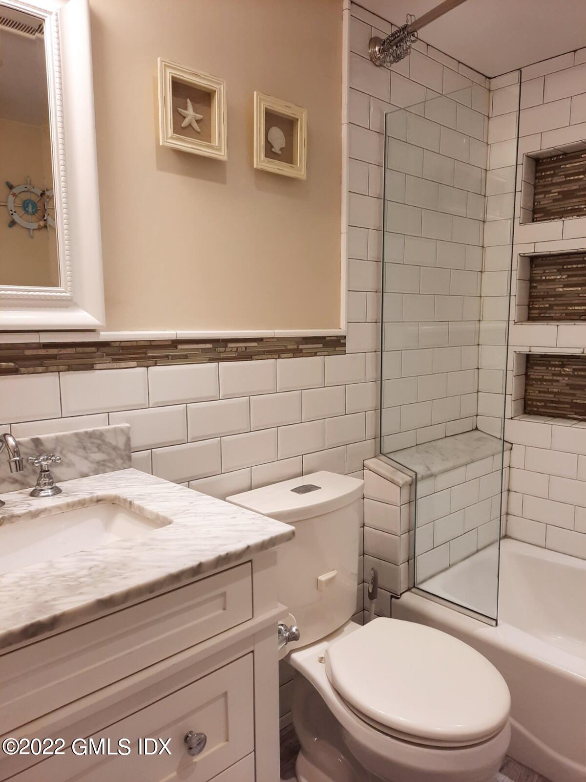 13 High Street Greenwich, CT 06830 - Photo 8 of 21 a bathroom with a sink a toilet and shower