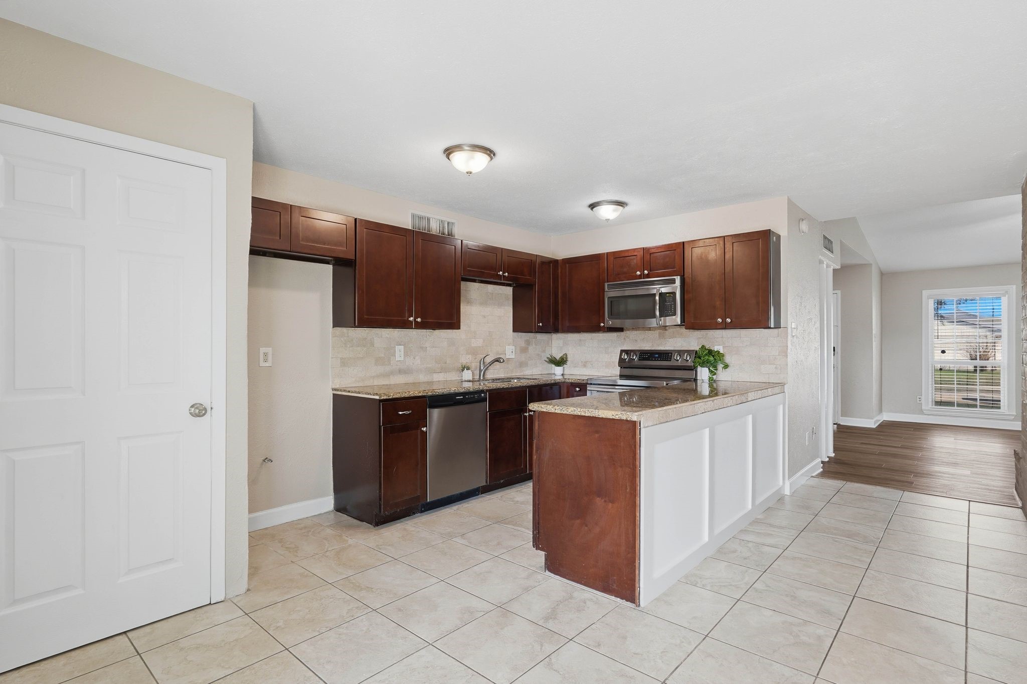 17223 Ranch Country Road Hockley, TX 77447 - Photo 13 of 36 Your kitchen features stainless steel appliances and a beautiful backsplash.