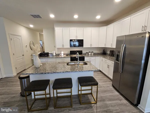 a view of kitchen island with granite countertop living room