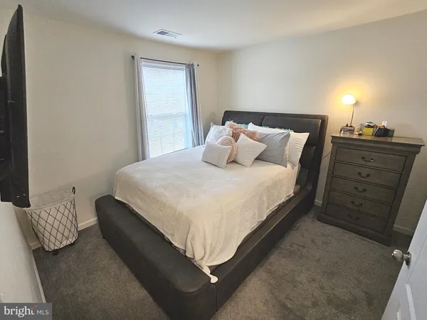 a bedroom with a bed and cabinet
