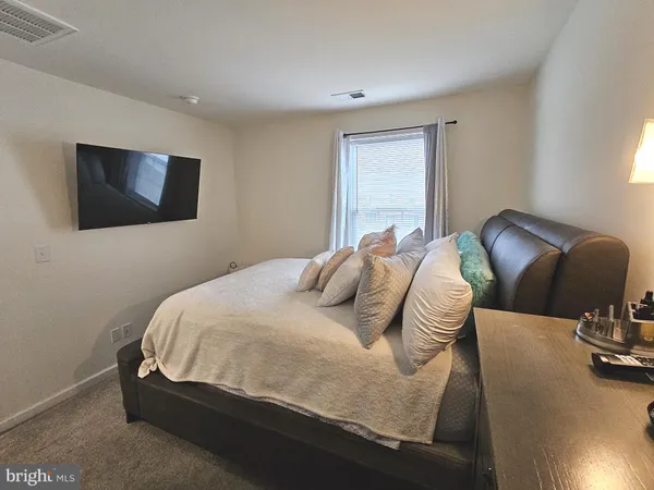 a bedroom with a bed and a night stand