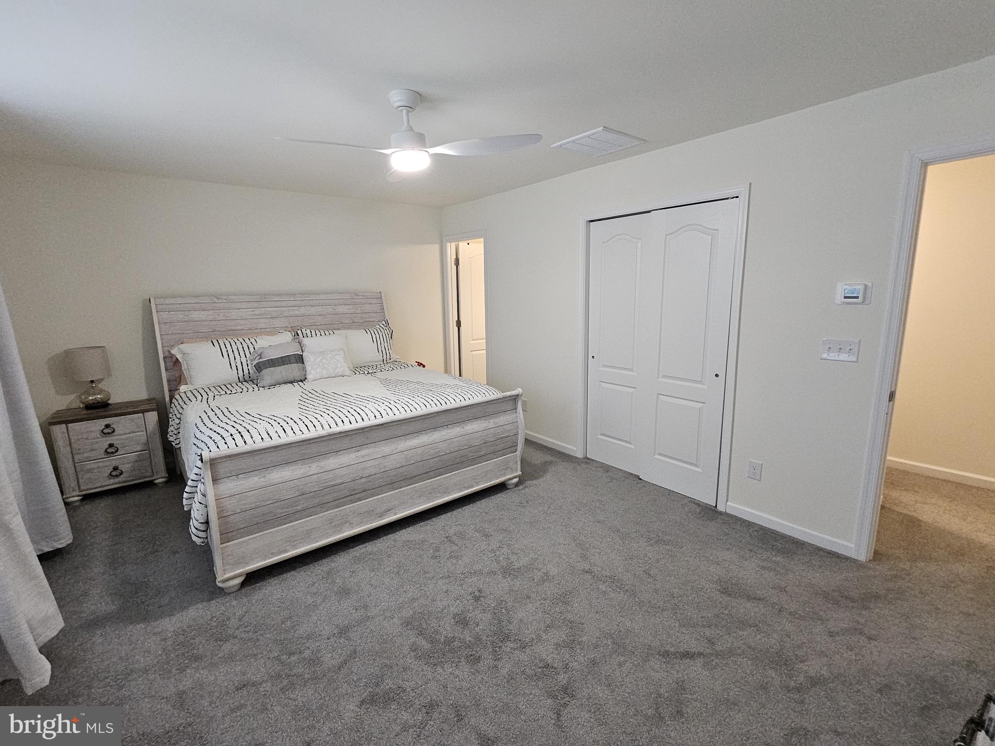 263 Tea Party Trail Dover, DE 19901 - Photo 26 of 36 a spacious bedroom with a bed and a cabinets