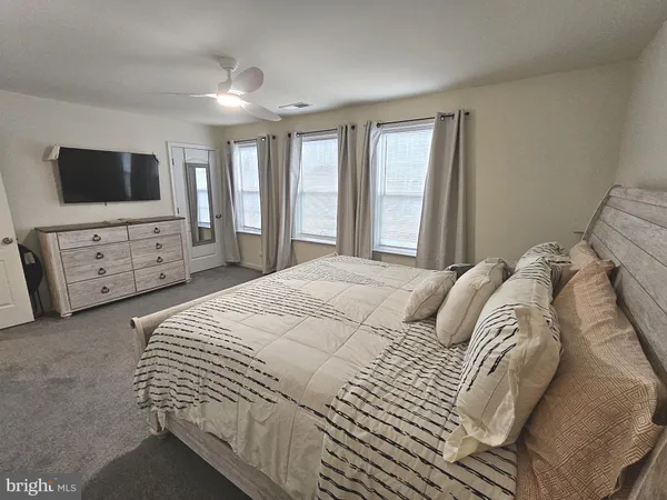 a spacious bedroom with a bed and a cabinets