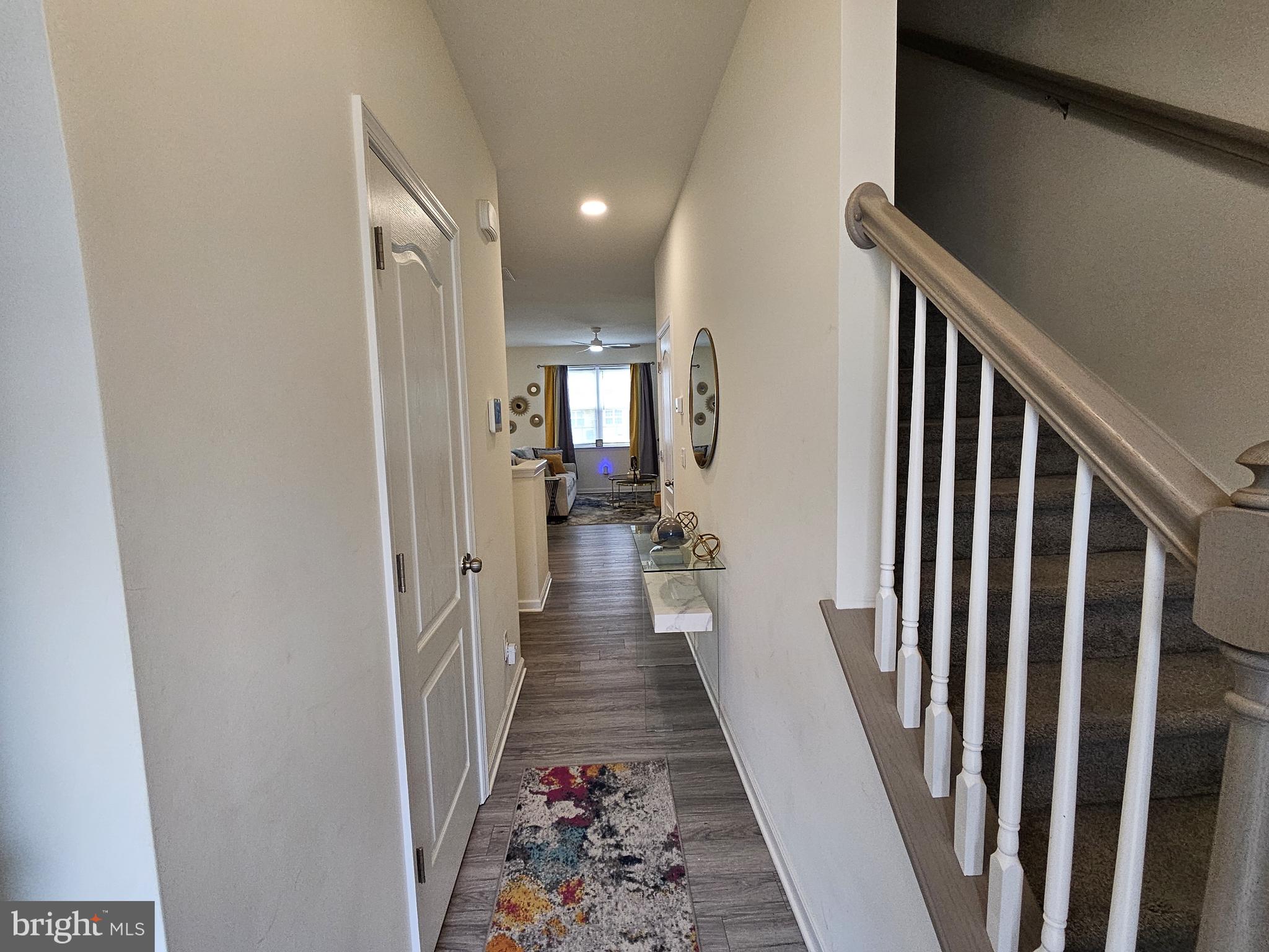 263 Tea Party Trail Dover, DE 19901 - Photo 4 of 36 a view of a hallway with wooden floor and stairs