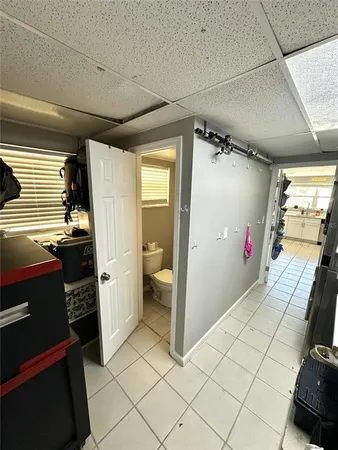 a white toilet sitting next to a bathroom sink and a shower