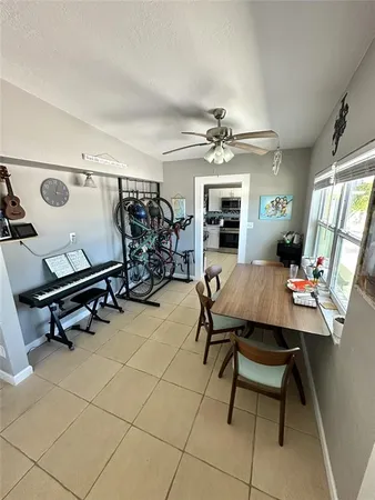 a view of a dining room with furniture and a chandelier