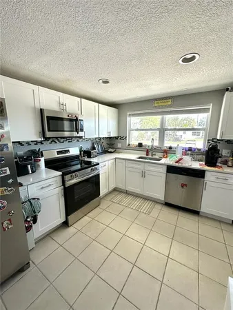 a kitchen with stainless steel appliances granite countertop a sink and cabinets