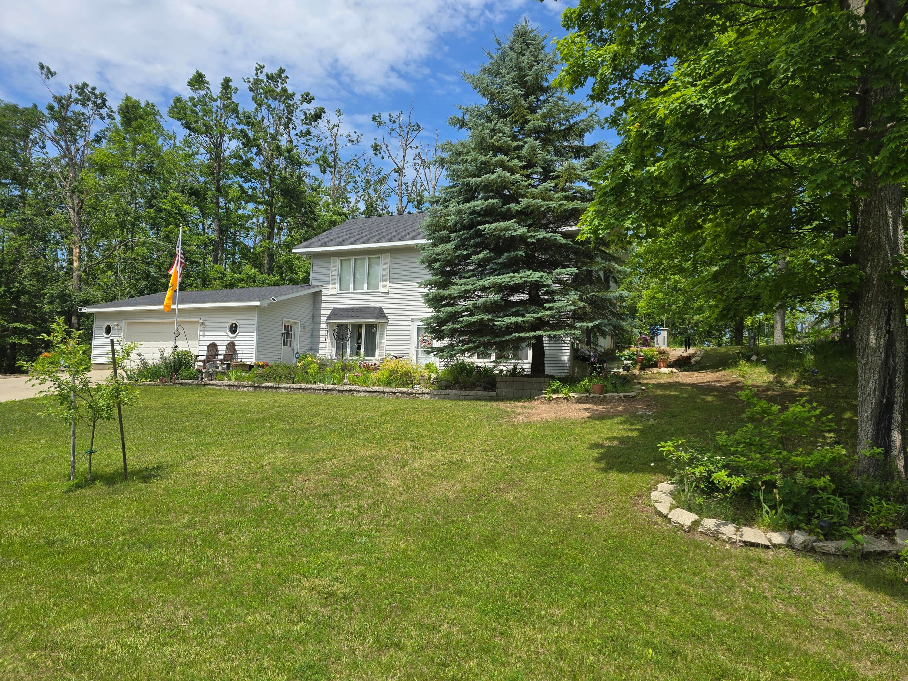 5500 Oley Lake Road Gaylord, MI 49735 - Photo 2 of 44 Front yard summer 2025