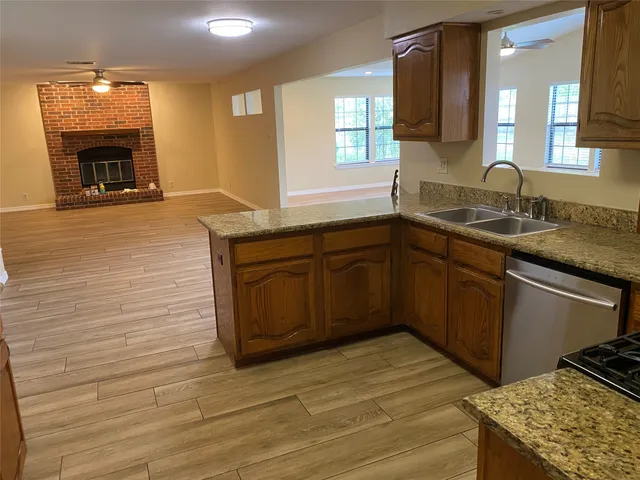 a kitchen with stainless steel appliances granite countertop a sink stove and cabinets