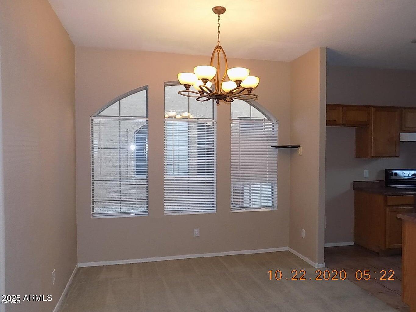 5337 East Harmony Avenue Mesa, AZ 85206 - Photo 11 of 27 a view of a room with a chandelier fan and windows