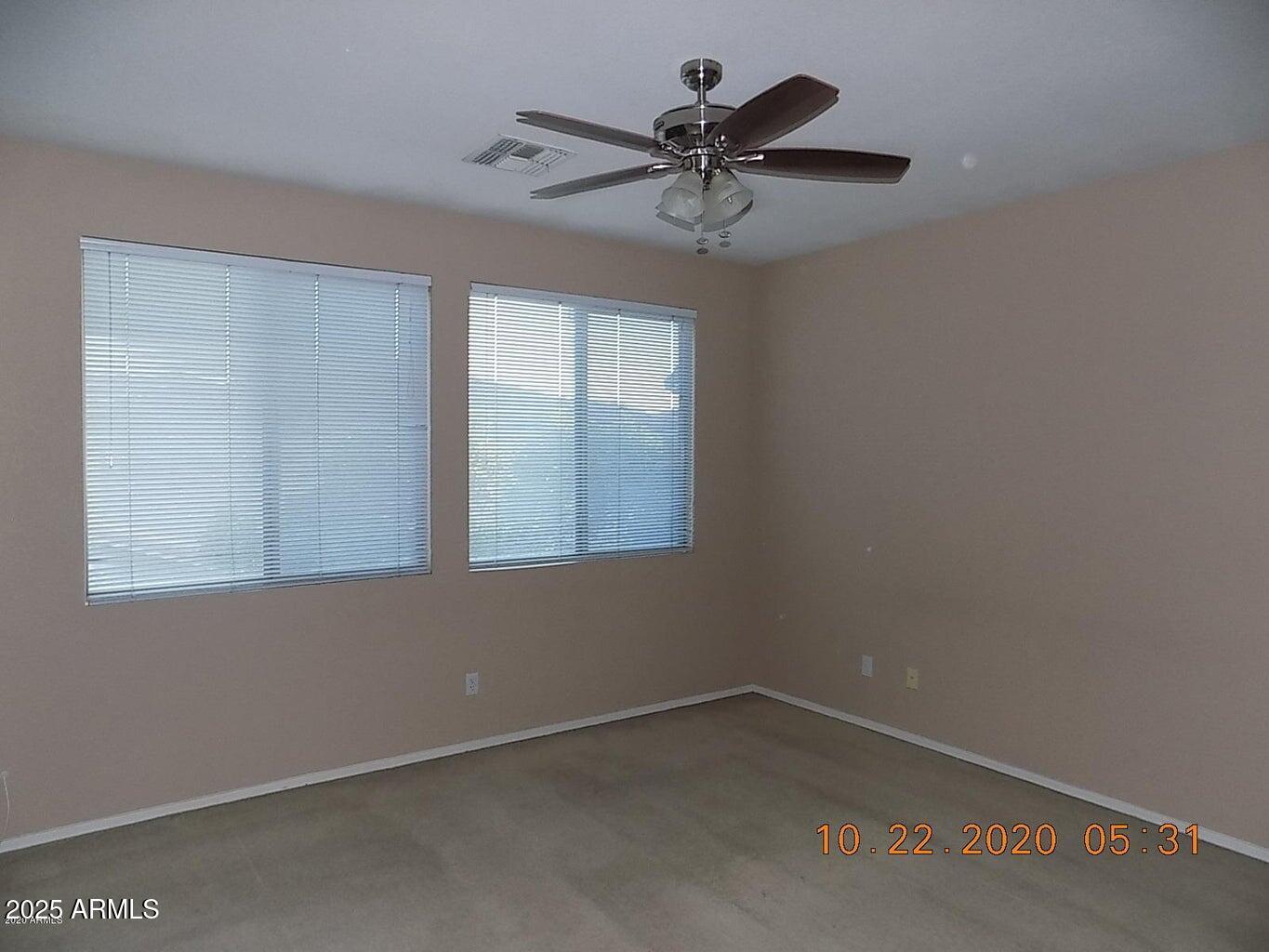 5337 East Harmony Avenue Mesa, AZ 85206 - Photo 19 of 27 an empty room with a window and a fan
