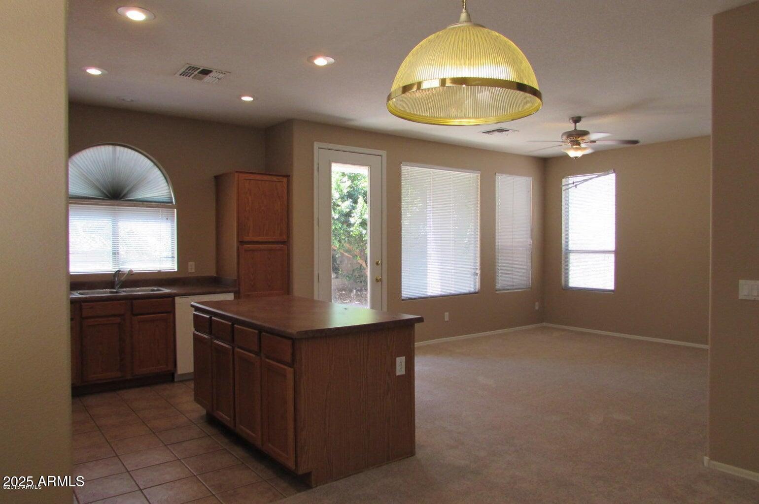 5337 East Harmony Avenue Mesa, AZ 85206 - Photo 3 of 27 a kitchen with stainless steel appliances granite countertop a stove and a sink