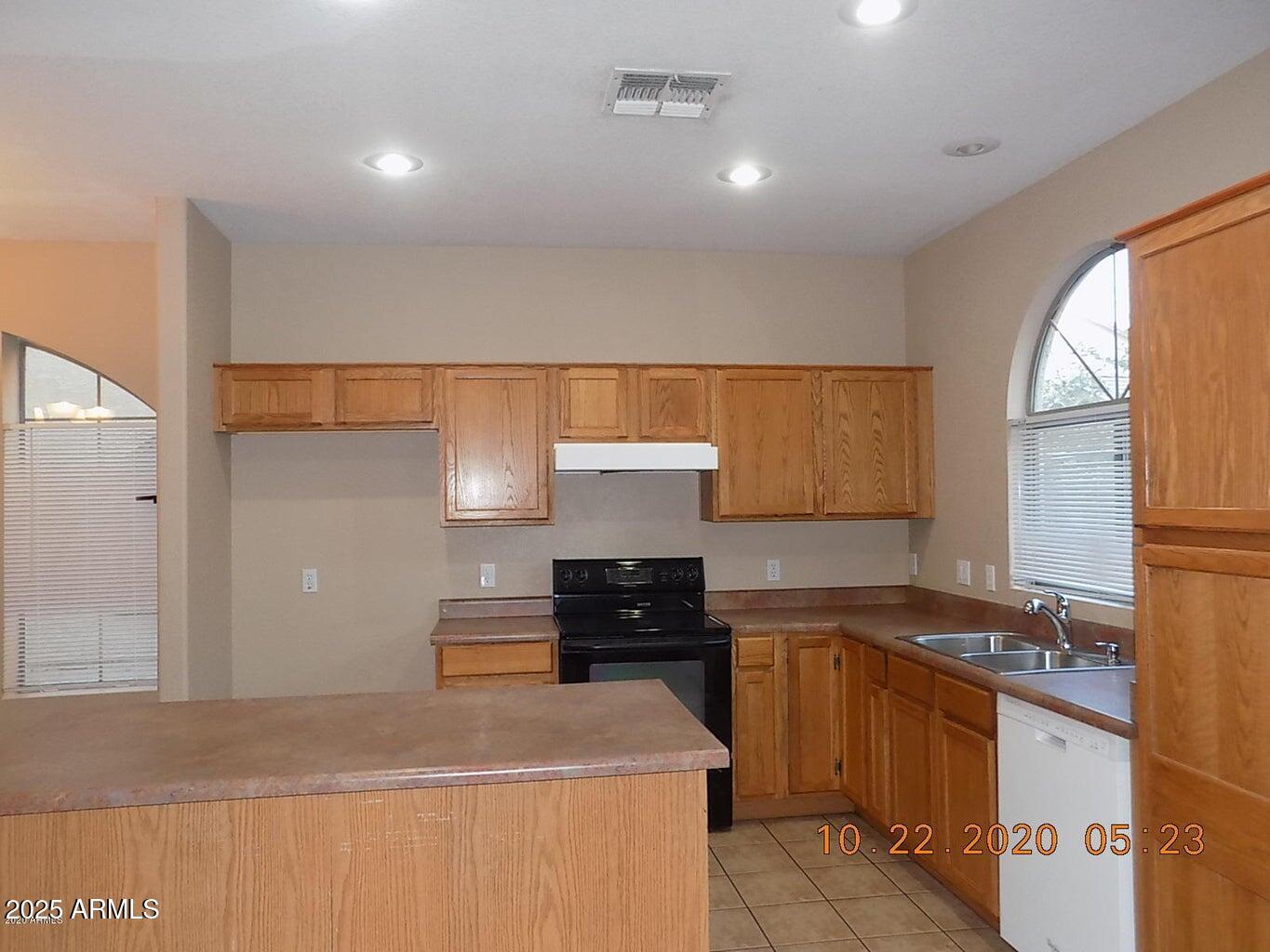 5337 East Harmony Avenue Mesa, AZ 85206 - Photo 5 of 27 a kitchen with stainless steel appliances granite countertop a sink and a stove