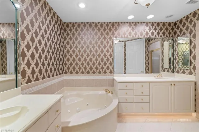 a bedroom with two beds and a chandelier