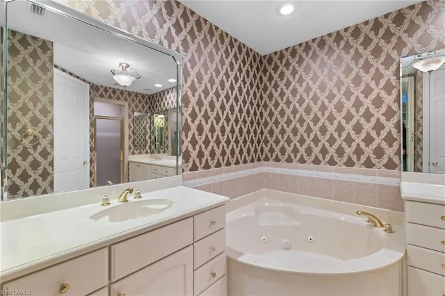 a bathroom with a sink a toilet a mirror and shower