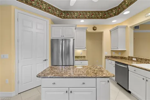 a view of living room with granite countertop couches and chandelier