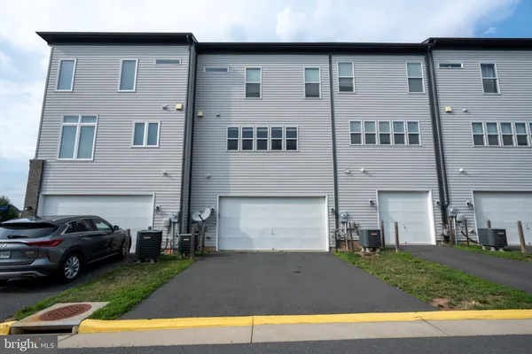 a couple of cars parked in front of a house