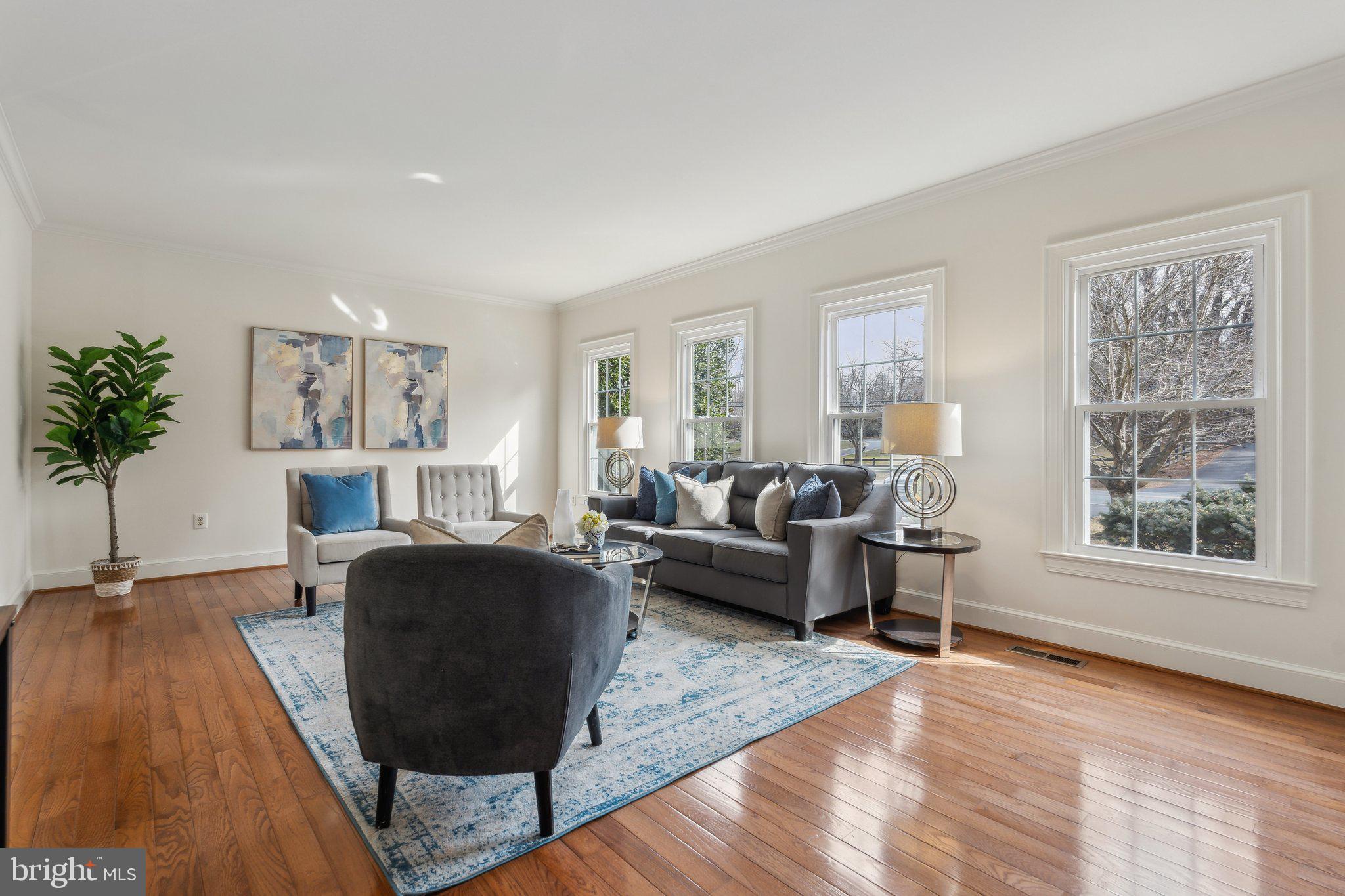 7708 Brickyard Road Potomac, MD 20854 - Photo 4 of 45 Sunny living room with 4 windows & hardwood floors