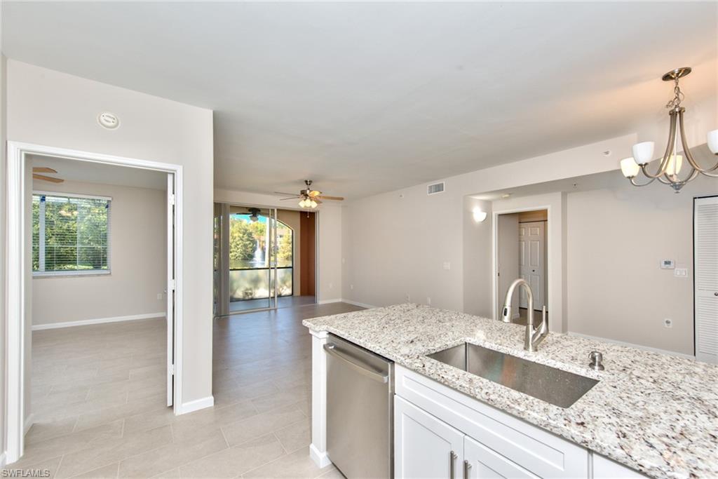 1200 Reserve Way, Unit 106 Naples, FL 34105 - Photo 2 of 31 a bathroom with a granite countertop sink and a mirror