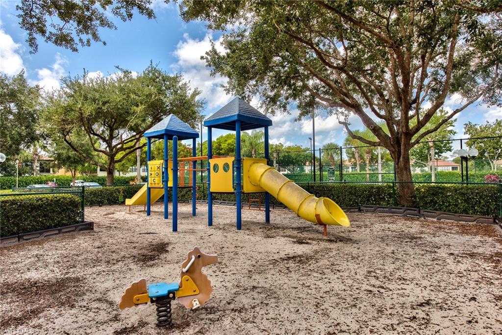1200 Reserve Way, Unit 106 Naples, FL 34105 - Photo 30 of 31 a view of park with slide and bench