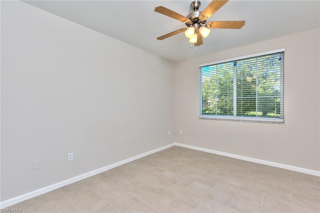 1200 Reserve Way, Unit 106 Naples, FL 34105 - Photo 9 of 31 an empty room with a window and a fan