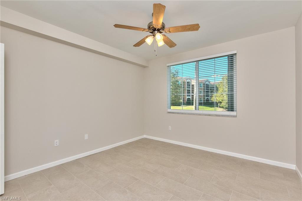 1200 Reserve Way, Unit 106 Naples, FL 34105 - Photo 10 of 31 an empty room with a window and a fan