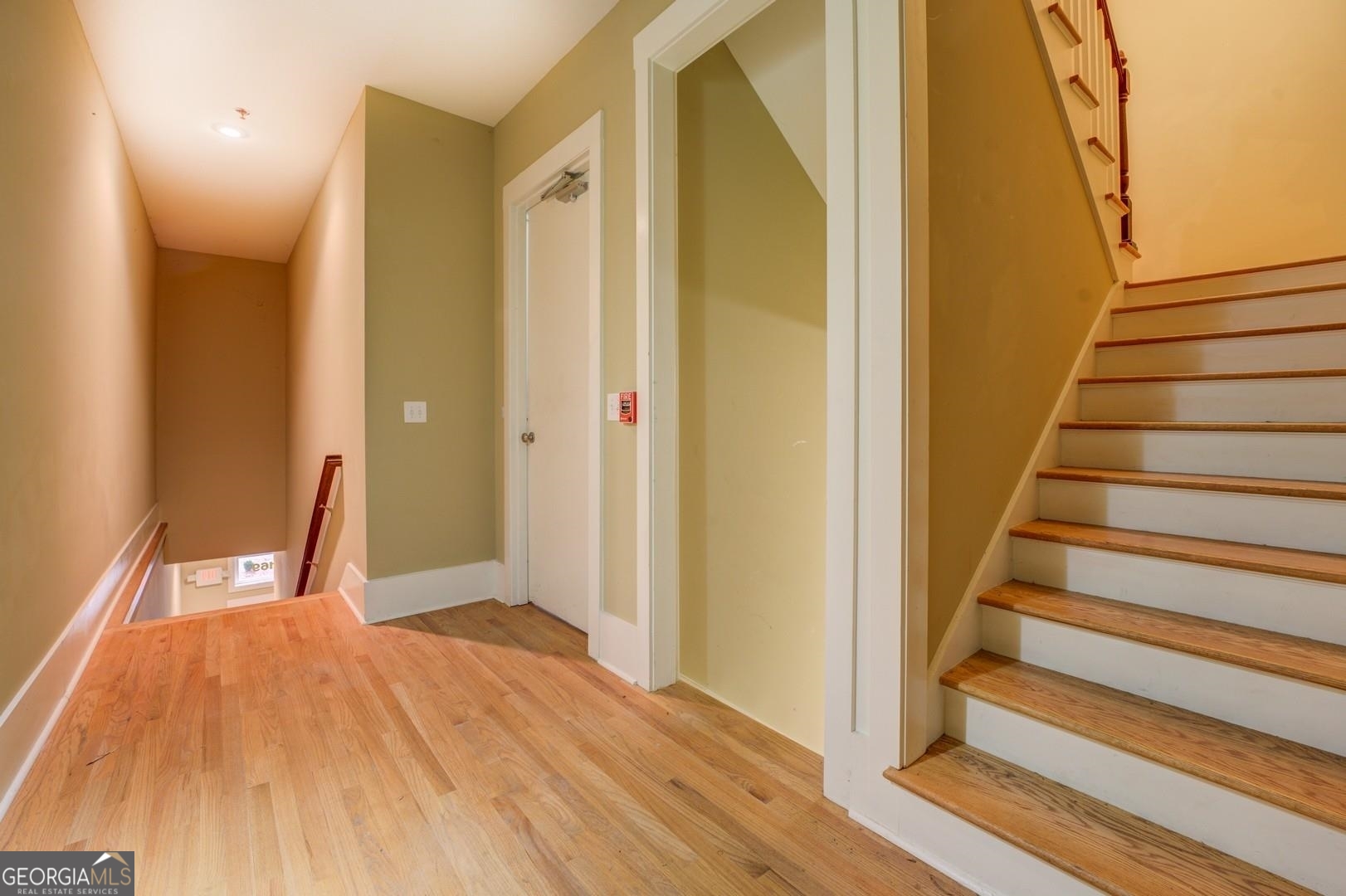 4165 Raphael Street Covington, GA 30014 - Photo 2 of 2 a view of a room with wooden floor and stairs