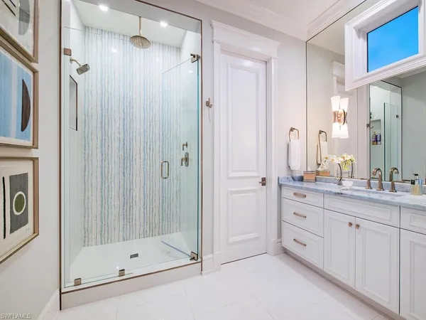 a bathroom with a double vanity sink a mirror a bathtub and shower