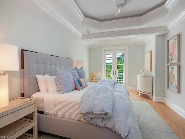 a bathroom with a granite countertop sink a toilet a mirror a vanity and shower