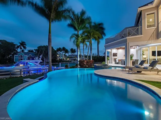 a view of a living room and livingroom with furniture wooden floor windows and a fireplace