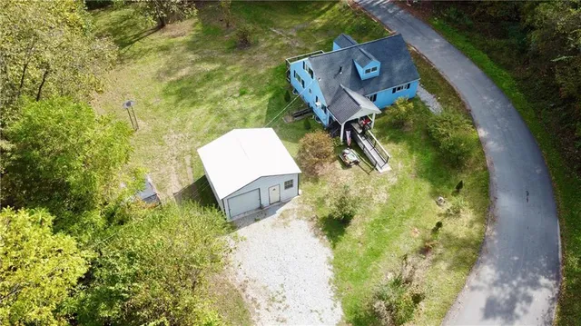 an aerial view of a house with garden space and sitting space