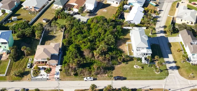 an aerial view of a residential apartment building with a yard and parking space