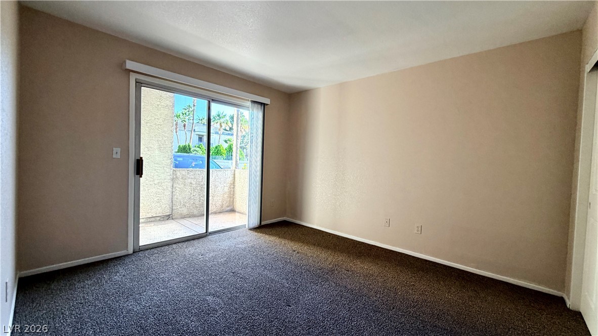 6250 West Flamingo Road, Unit 4 Las Vegas, NV 89103 - Photo 29 of 45 This living area features a glass sliding door, opening to a private patio.