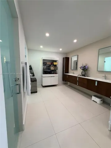 a large white room with a large mirror and vanity