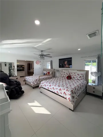 a bedroom with a bed a couch and dresser