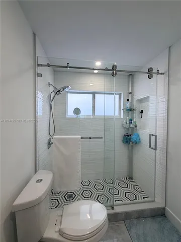 a bathroom with a toilet and shower