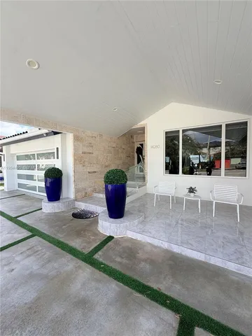 a view of a patio with table and chairs and potted plants