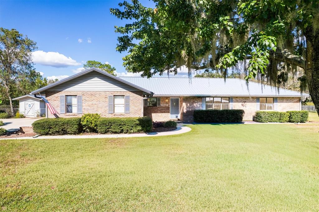 4479 Southeast 2nd Avenue Keystone Heights, FL 32656 - Photo 1 of 1 a front view of a house with a yard and garage