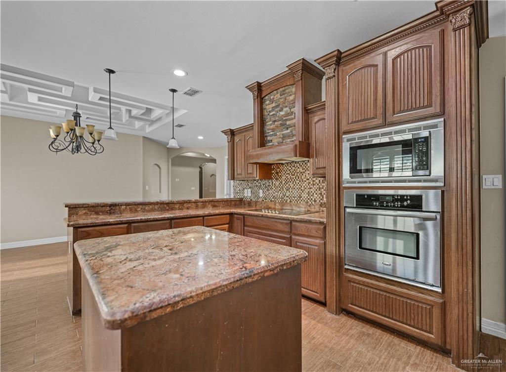 2608 Flamingo Avenue Mission, TX 78574 - Photo 7 of 27 a kitchen with a stove and a microwave