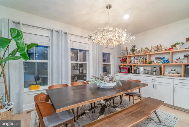 a view of a dining room with furniture and chandelier