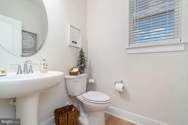 a bathroom with a toilet a sink and a mirror