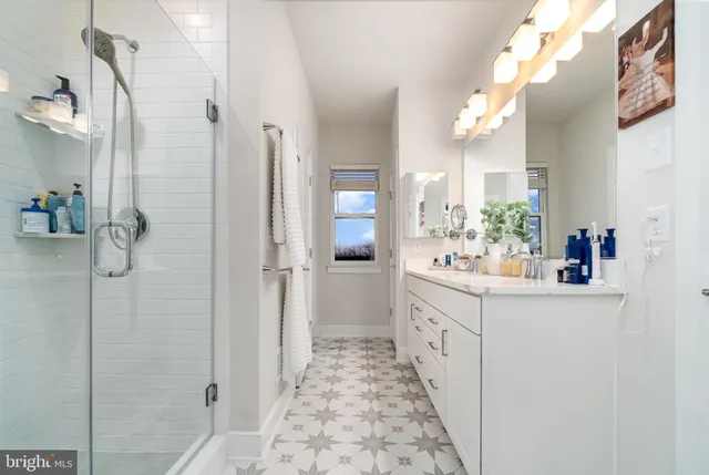 a bathroom with a double vanity sink and mirror