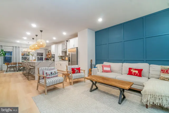 a living room with furniture and kitchen view