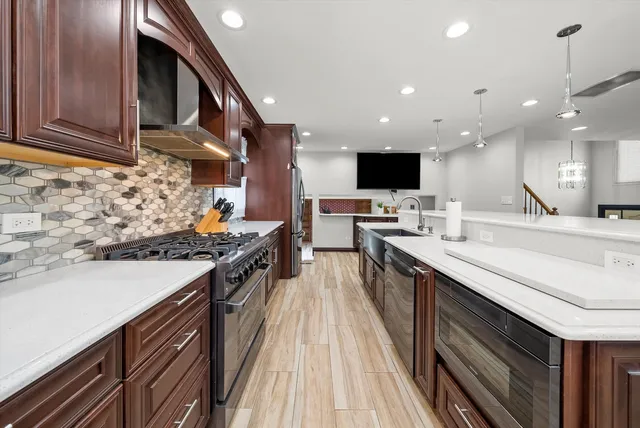 a kitchen with stainless steel appliances granite countertop a stove and a sink
