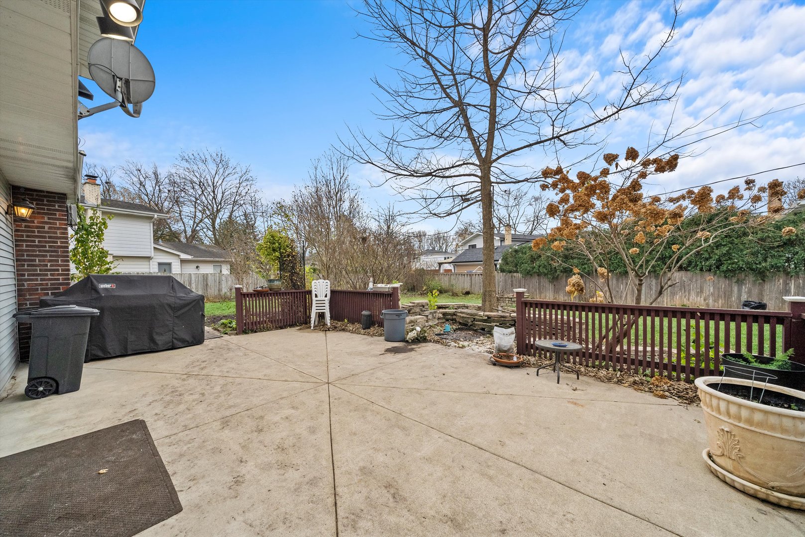 912 Sumac Lane Mount Prospect, IL 60056 - Photo 28 of 41 a view of a patio with table and chairs with wooden fence and plants