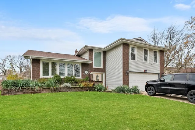 a front view of house with yard and green space