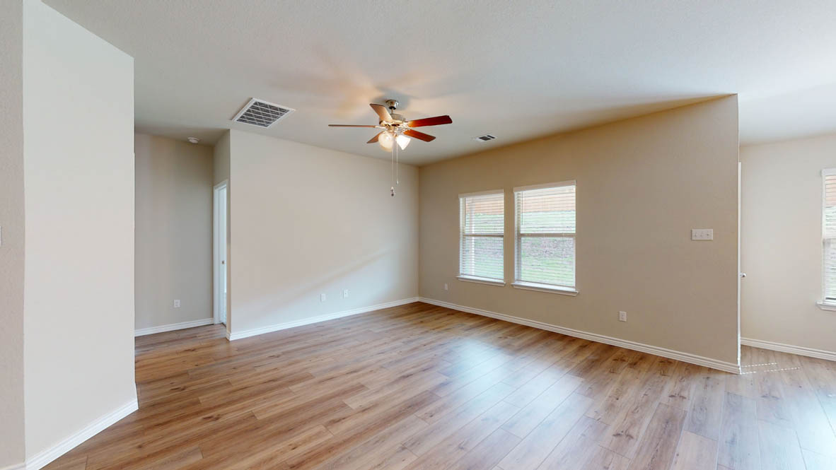 429 Creekfall Road Burnet, TX 78611 - Photo 13 of 28 Hardwood floors and ample natural light define this inviting open-concept living area.