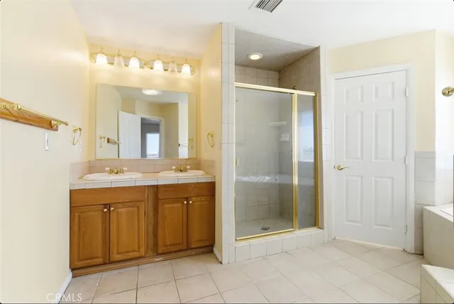 a bathroom with a shower sink and mirror